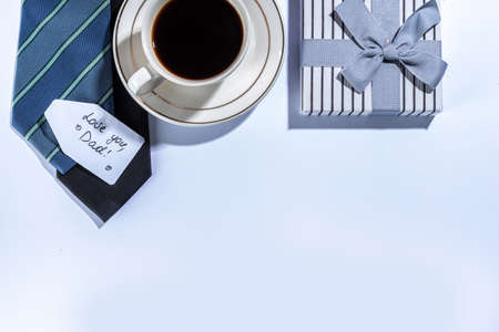 Father day greeting card background. Fathers day concept with gift box, tools and ties, coffee cup,...