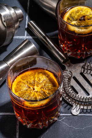 Hard alcohol drink with orange slice garnish. Negroni cocktail with dried orange and whiskey, copy spaceの写真素材
