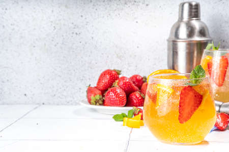 Homemade Summer Sparkling White Wine Sangria. Cold fizz fruit and berry infused alcohol drink, non-alcohol lemonade with fresh strawberry and orange, copy spaceの写真素材