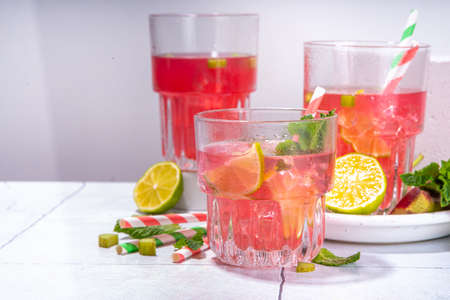 Refreshing homemade pink rhubarb lemonade. Cold summer drink raw rhubarb, lime slices and mint, copy spaceの写真素材