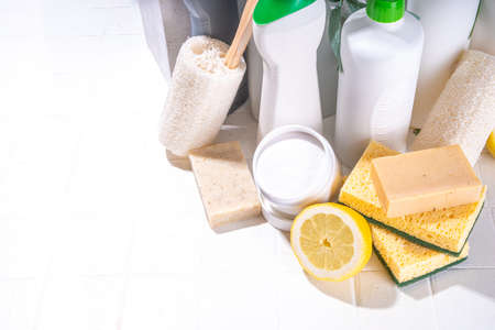 Eco friendly organic cleaning concept. Eco-friendly cleaner utensils - eco brushes, tools sponges, natural cleaning products, soda, soap, lemon, vinegar, bottles with green leaves on white backgroundの写真素材