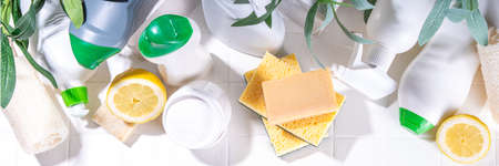 Eco friendly organic cleaning concept. Eco-friendly cleaner utensils - eco brushes, tools sponges, natural cleaning products, soda, soap, lemon, vinegar, bottles with green leaves on white backgroundの写真素材