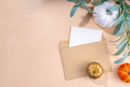 Fall seasonal flat lay. Autumn seasonal holidays background in pink colors. White, orange, golden pumkins decor for thanksgiving, fall holidays, invitation mock up backgroundの写真素材