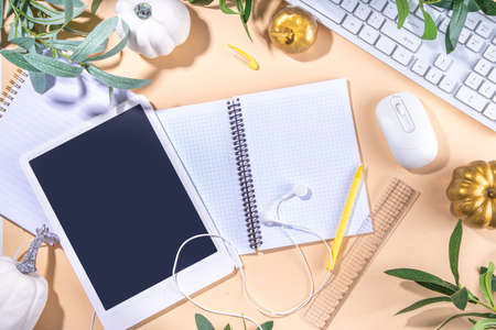 Simple pastel autumn office work, education flatlay top view copy space. Tablet with empty screen...