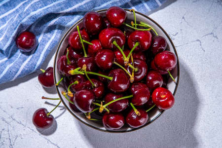 Bowl of fresh cherry fruit. Portion of fresh raw organic cherries on white background