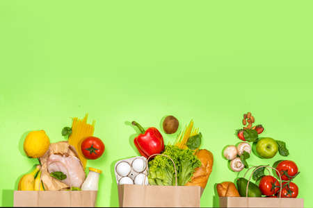 Fresh vegetables, meat, bread fruits in paper grocery bag. Delivery healthy food background. Healthy food cooking ingredients on white,background, Shopping food supermarket and clean vegan eatingの写真素材