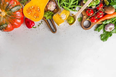 Autumn cooking background. Organic autumn harvest vegetables, raw vegan ingredients for cooking traditional thanksgiving and fall food on white background, top viewの写真素材
