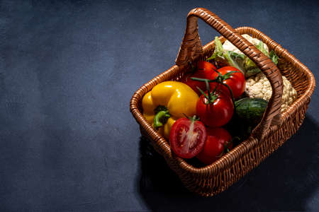 Autumn vegetable cooking background. Organic fall harvest farm vegetables, mushrooms. Various vegetarian ingredients set for cooking dinner on black kitchen background, top view copy spaceの写真素材
