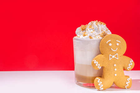 Autumn winter coffee latte set, coffee drink assortment with various toppings - gingerbread caramel, mocha chocolate, candy cane peppermint latte, trendy bright high-colored red and white backgroundの写真素材