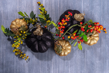 Black and cold colored pumpkins on gray wooden background. Minimalist style Halloween Thanksgiving background copy spaceの写真素材