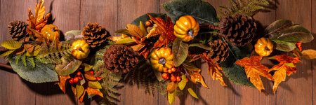 Festive autumn background. Old wooden plank table with fall decoration, small pumpkins, berries and...