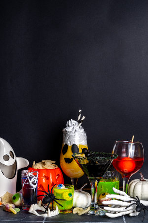 Halloween party bar festive drink, set various colorful alcohol, non-alcohol cocktails, drinks with halloween characters costumes hands, holiday decor and symbolsの写真素材