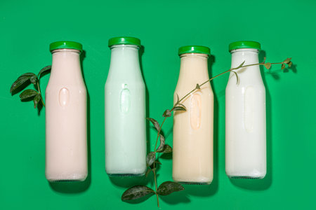 keto, paleo and vegan diet concept. Set of nut milks, bottles with various non-dairy nut milk - pistachio, walnut, hazelnut, peanut, almond, cashew, pecan, brazil nut, seeds, coconutの写真素材