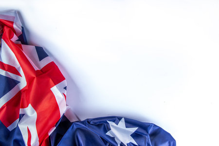 Australia Day greeting card Background with  australian flag, silver stars, paper red, blue, white decor, over white background, frame copy spaceの写真素材