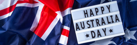 Australia Day greeting card Background with  australian flag, silver stars, lightbox with text Happy Australia day, paper red, blue, white decor, over blue background copy spaceの写真素材