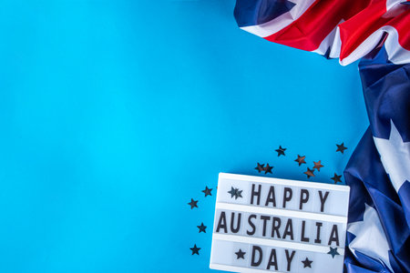 Australia Day greeting card Background with  australian flag, silver stars, lightbox with text Happy Australia day, paper red, blue, white decor, over blue background copy spaceの写真素材
