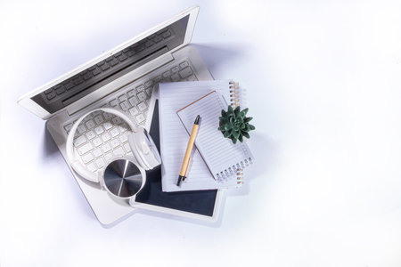Simple minimalist home office desk workspace with laptop, cactus succulents, on light white...