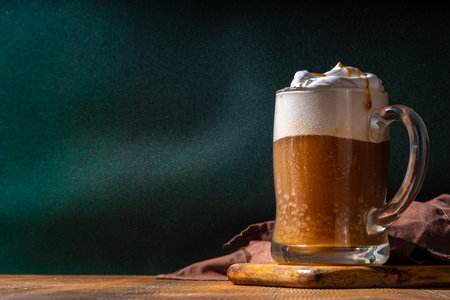 Sweet Homemade Butterscotch Butter Beer, non-alcohol beer styled caramel autumn winter drink, with...