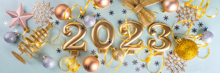New year 2023 celebration greeting card background Gold numbers 2023 with golden party decoration, stars confetti on blue background. Flat lay Merry Christmas, Noel happy New Year holidays bannerの写真素材
