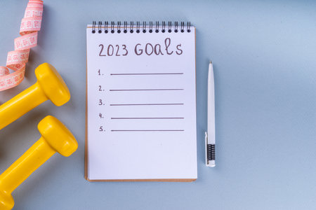 Simple background with Notebook with New's Year Resolutions massage. New Year goals List 2023, plan listing of new year beginnings goals, resolutions setting. Flat lay copy spaceの写真素材