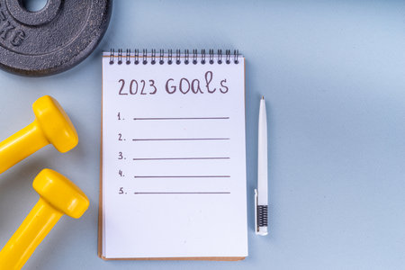Simple background with Notebook with New's Year Resolutions massage. New Year goals List 2023, plan listing of new year beginnings goals, resolutions setting. Flat lay copy spaceの写真素材