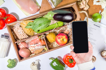 Meal Kit Delivery Concept. Set various healthy dishes food ingredients meat, vegetables, fruit, spices with recipes for cooking. Online ordering chef foods ingredients, grocery deliveryの写真素材