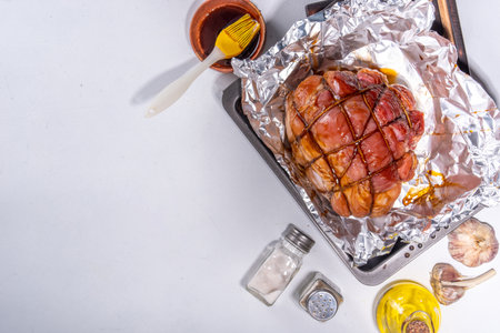Cooking baking pork meat. Traditional recipe for glazed ham, with spices and ingredients. Easter homemade glazed ham preparation process, female hands grease apply glaze on meatの写真素材