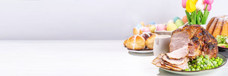 Traditional glazed baked pork. Homemade roasted ham, on festive served Easter lunch or brunch tableの写真素材