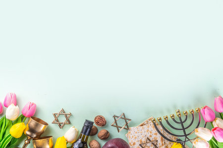Passover, Pesah background. jewish Easter Passover spring holiday celebration, with accessories - menorah, matzo, spring flowers, wine bottle, gold wine glass, jewish david stars, copy space top viewの写真素材