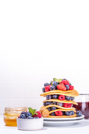 Healthy summer morning breakfast pancakes with fresh berry. Stack of traditional pancakes with...