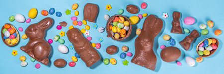 Easter chocolate egg and bunny background. High-colored flat lay with chocolate bunny and rabbits,...
