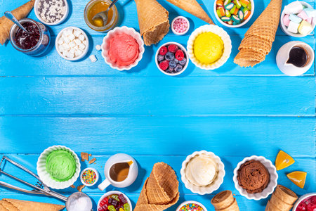 Ice cream festival background, Summer ice cream buffet with various gelato sundaes flavors. sweet toppings and sprinkles, high-colored blue wooden background to view copy spaceの写真素材