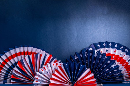 Happy Labor Day, Presidents Day, Fourth of July Independent Day, Memorial day, Columbus day background. Dark blue background with USA flag color paper fans and decorations, party accessoriesの写真素材