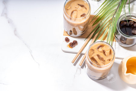 Iced tapioca coffee latte or boba pearl bubbles milk tea, asian trendy cold coffee drink with...