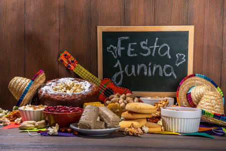 Traditional Festa Junina Summer Festival Carnival Food. Traditional Brazilian Festa Junina dishes and snacks - popcorn, peanuts, corn cake,beans, cookie, pacoca, with holiday decor and accessoriesの写真素材