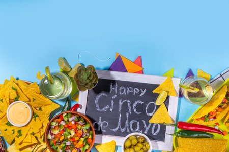 Cinco de mayo party food. Mexican holiday Cinco de mayo traditional dishes, snacks, tortilla corn chips, nachos, tacos, salsa, sauces. Friends and family feast background top view copy spaceの写真素材