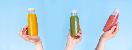 Green, orange and red smoothie in portion bottles, Mix of colourful healthy smoothie or juice drinks...