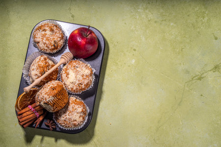 Apple pie crumble streusel muffins, Sweet autumn baking pastry with red apple slices, cinnamon and spices and crumble toppingsの写真素材