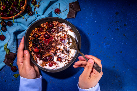Chocolate and cherry oatmeal. Sweet breakfast bowl with cherry, chocolate drops and sauce, oatmeal...