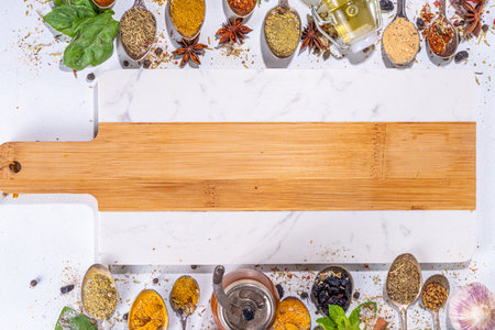 Spices for cooking on white background. Different seasonings, spices and herbs paprika, pepper, turmeric, salt, basil, mint, cinnamon, garlic and other aromatic ingredients for preparation foodの写真素材