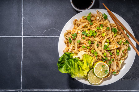 Asian shimeji noodles dish. Chow Mein noodles pasta, with stir fried vegetables, soy sauce and shimeji mushroomsの写真素材