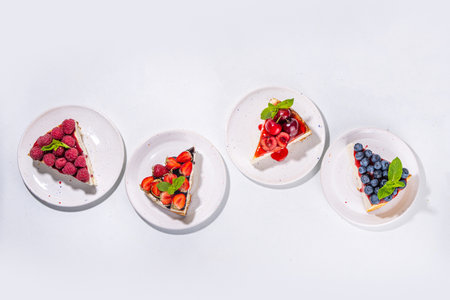 Summer cafe baking menu background, sweet cheesecake portion slices with various toppings, jam and berry fruits - strawberry, blueberry, raspberry, cherryの写真素材
