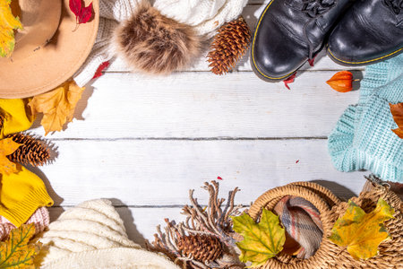 Preparation for fall and winter season, autumn cozy clothes and decor background, wooden table top...