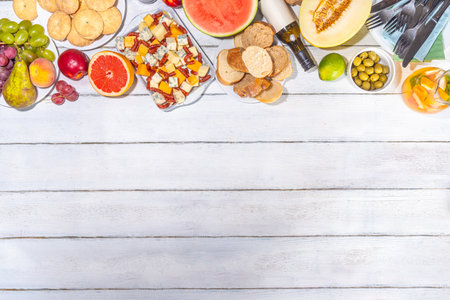 Buon Ferragosto (happy in italian language) holiday background. Summer Italian harvest festival August 15  brunch, family party antipasto foods with watermelon, melon, grapes, cheese, snacks, drinksの写真素材