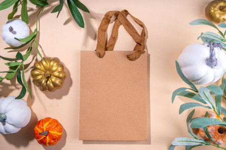 Fall seasonal flatlay. Autumn seasonal holidays background in pink colors. White, orange, golden pumkins decor for thanksgiving, fall holidays, invitation mock up backgroundの写真素材
