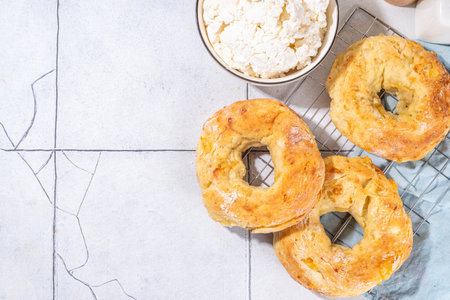 Cottage cheese bagels. Trendy curd cheese baking, bread rings with cottage cheese and parmesan, savory non-sweet breakfast baked cheesy donutsの写真素材