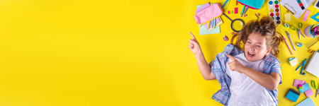 Cute emotional girl ready to back to school with various school supplies, education accessories on bright yellow backgroundの写真素材