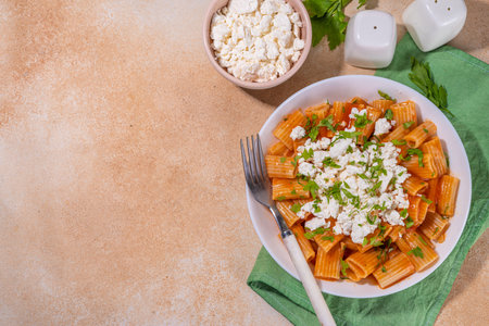 High-protein diet lunch, homemade rigatoni pasta with tomato sauce and cottage cheese, italian vegan healthy food, copy spaceの写真素材