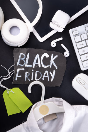 Black friday sale background with sale tags, clothes, laptop, headphones, smartphone, tablet, sale items, flat lay top view copy spaceの写真素材