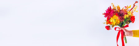 Autumn holidays greeting card background. Autumn red, orange, bright flowers and leaves a big bouquet on a background case. Teacher's Day, Thanksgiving Day, Halloween backgroundの写真素材